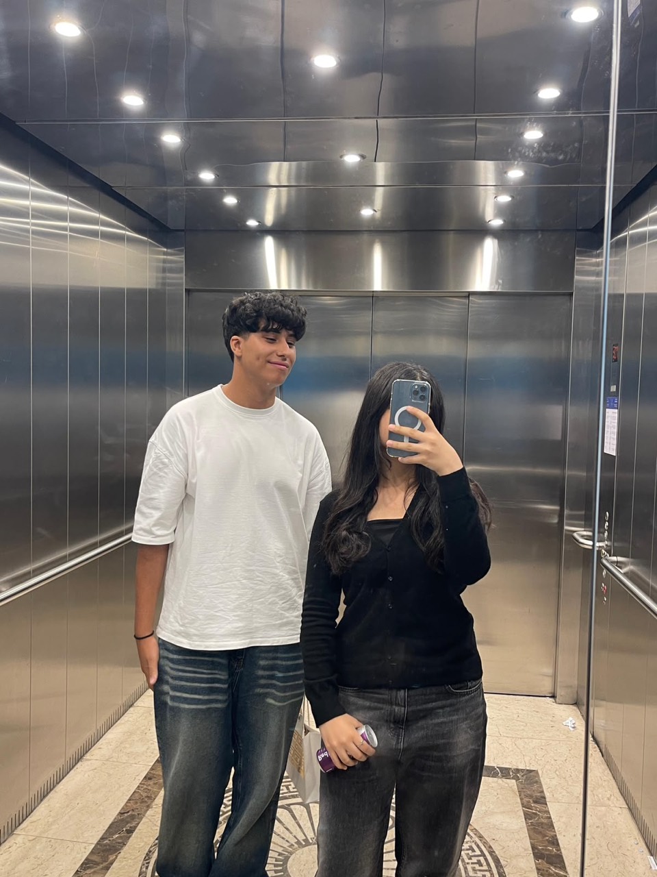 Anas and Farida taking an elevator mirror photo