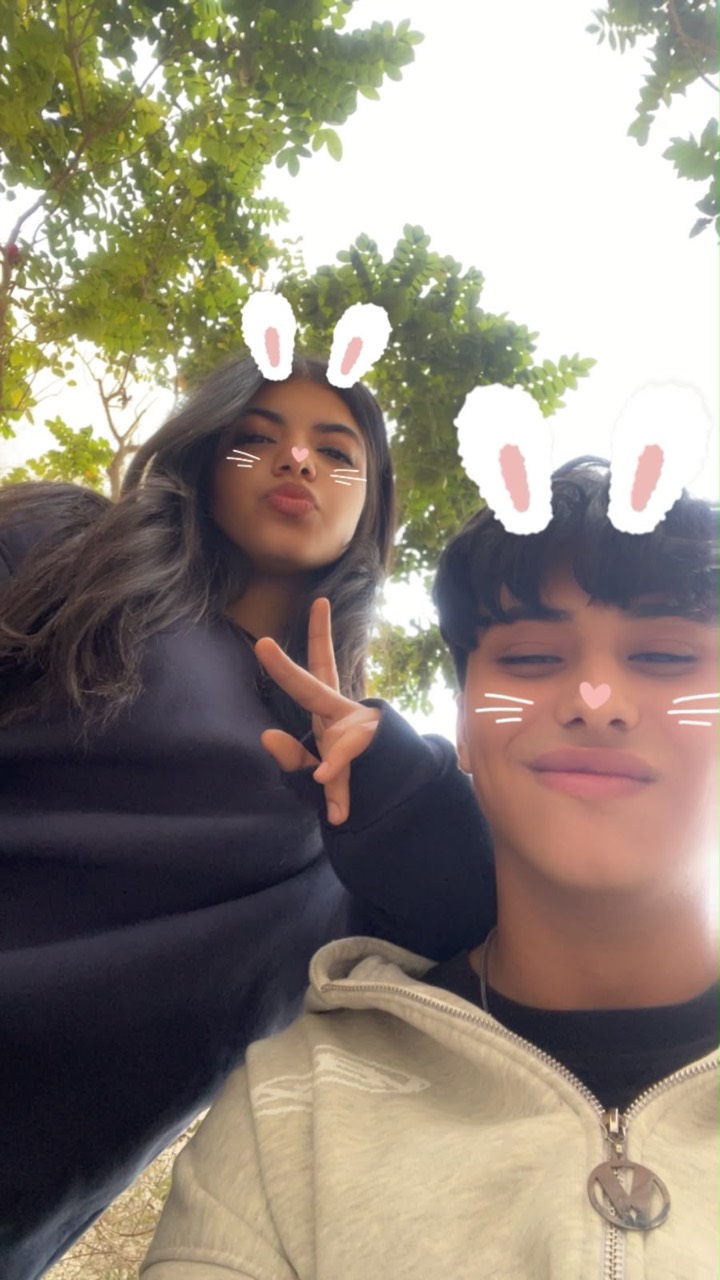 Anas and Farida under the trees with a bunny filter